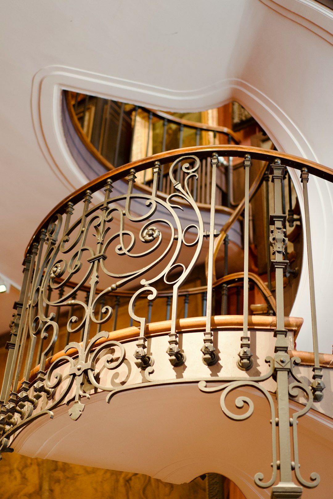 Sweeping ornate spiral staircase inside a luxury residence
