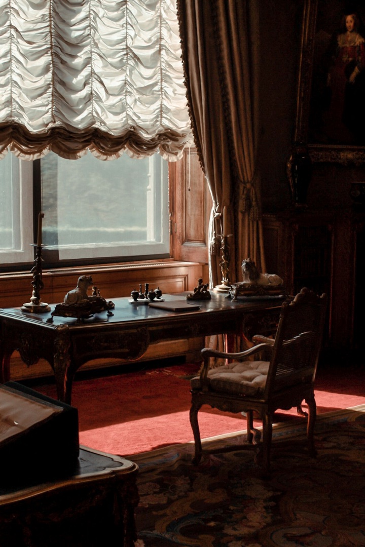 Elegant period study with a writing desk by a sunlit window