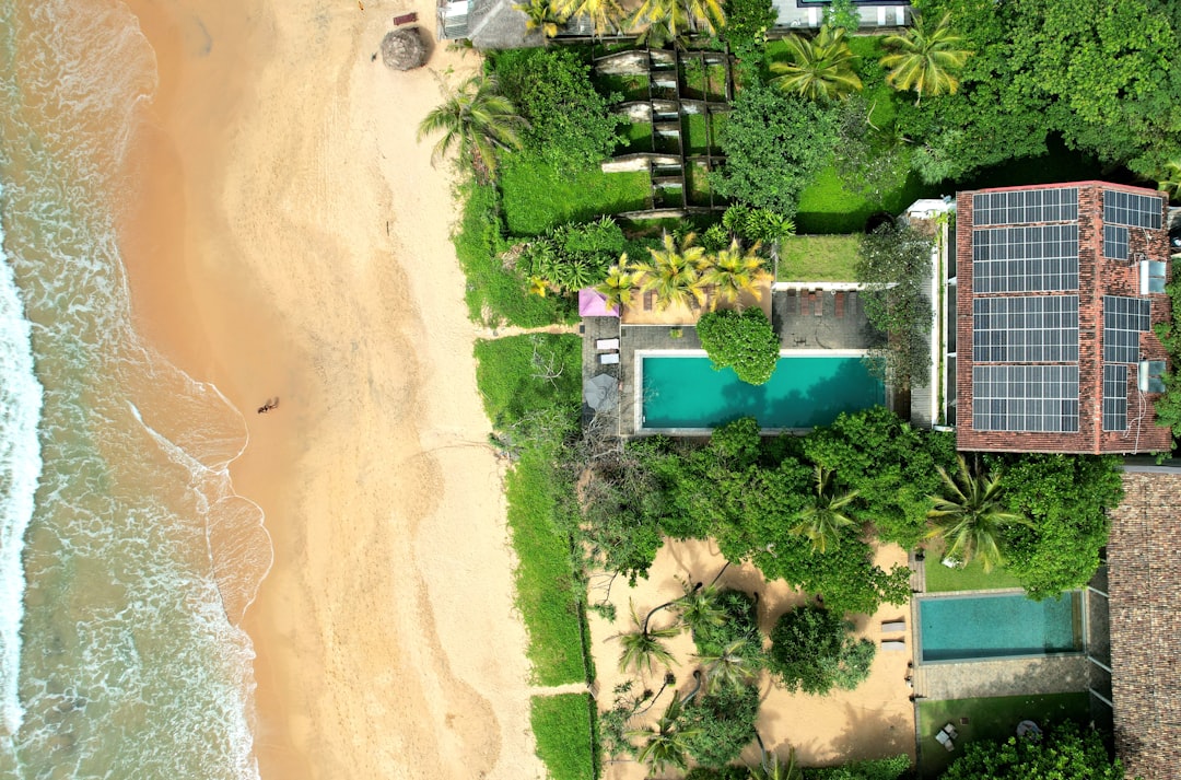 Aerial view of a beachfront estate beside turquoise water in Mauritius